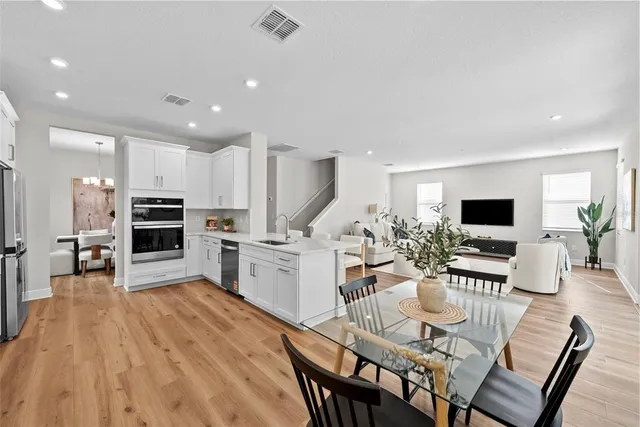 a living room with furniture wooden floor and a flat screen tv