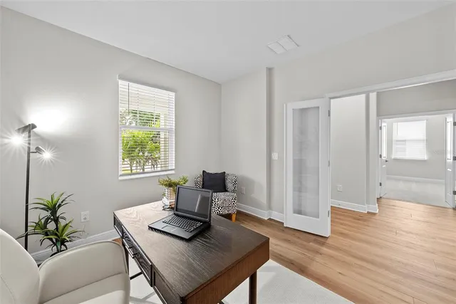 a view of a workspace with furniture and a potted plant