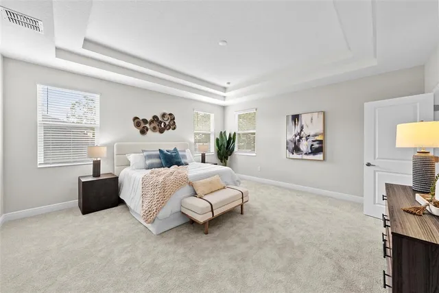 a bedroom with a bed and a painting on the wall