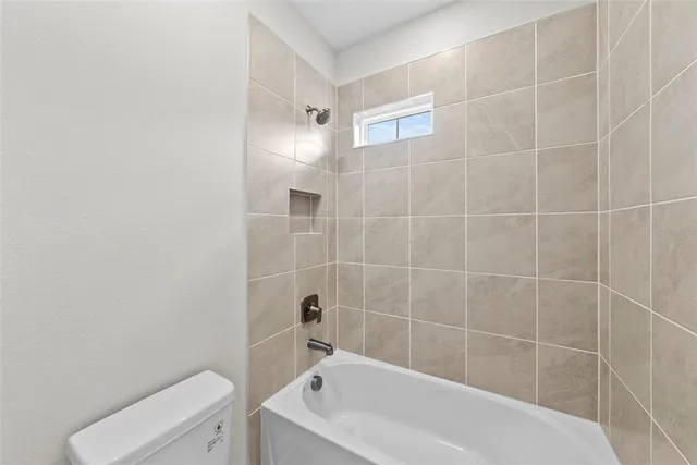 a bathroom with a bathtub and toilet