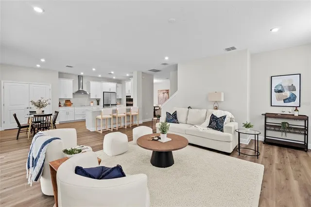 a living room with furniture kitchen view and a table