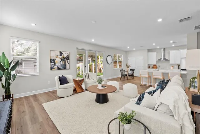 a living room with furniture potted plant and a window