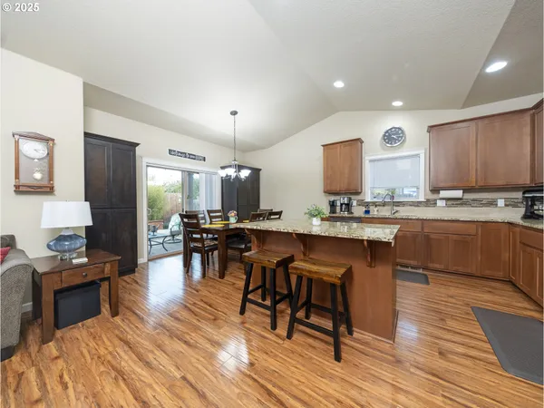 a kitchen with a sink cabinets and wooden floor