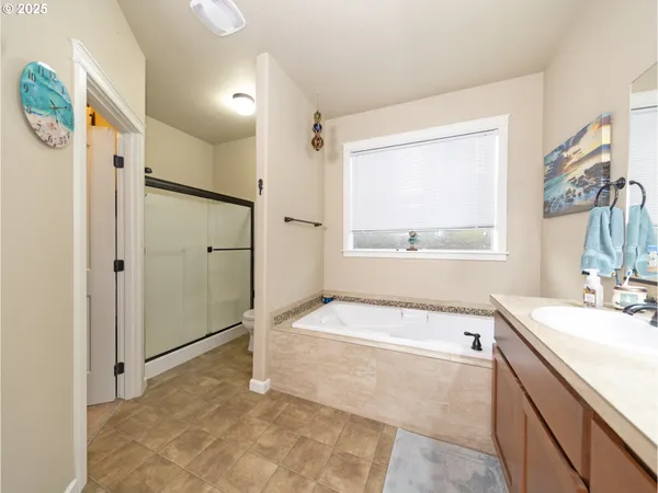 a bathroom with a tub sink and mirror