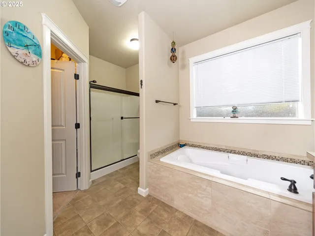 a spacious bathroom with a tub and a shower