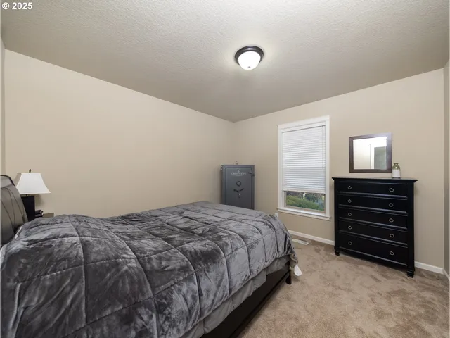 a bedroom with a bed and a lamp