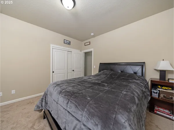 a bedroom with a bed and a lamp