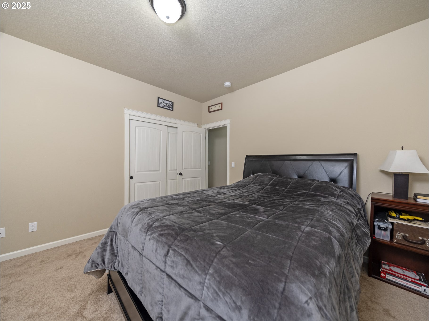 1020 East Fourth Street Yamhill, OR 97148 - Photo 27 of 46 a bedroom with a bed and a lamp