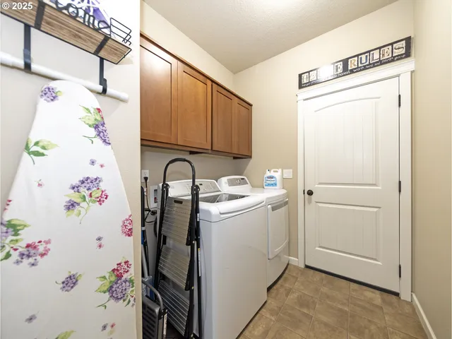 a view of storage and utility room with a window