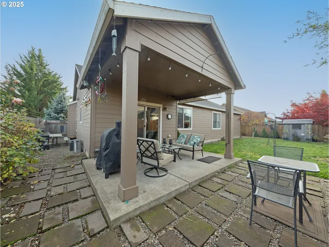 a view of a patio with table and chairs potted plants with wooden fence