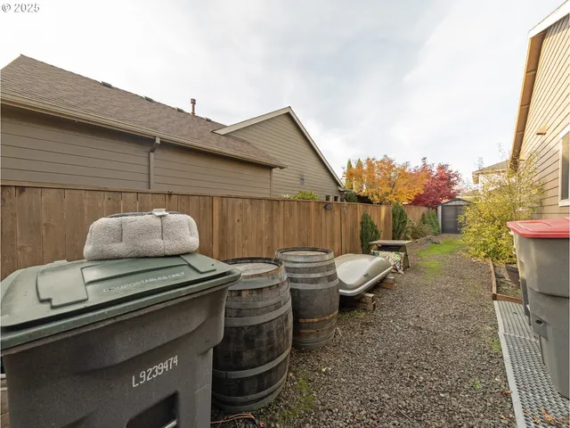 a backyard of a house with table and chairs