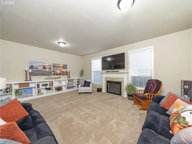 a living room with furniture and a fireplace