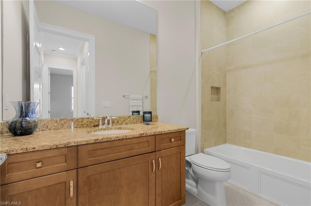 5731 Highbourne Drive Naples, FL 34113 - Photo 12 of 20 Full bathroom with vanity, tiled shower / bath combo