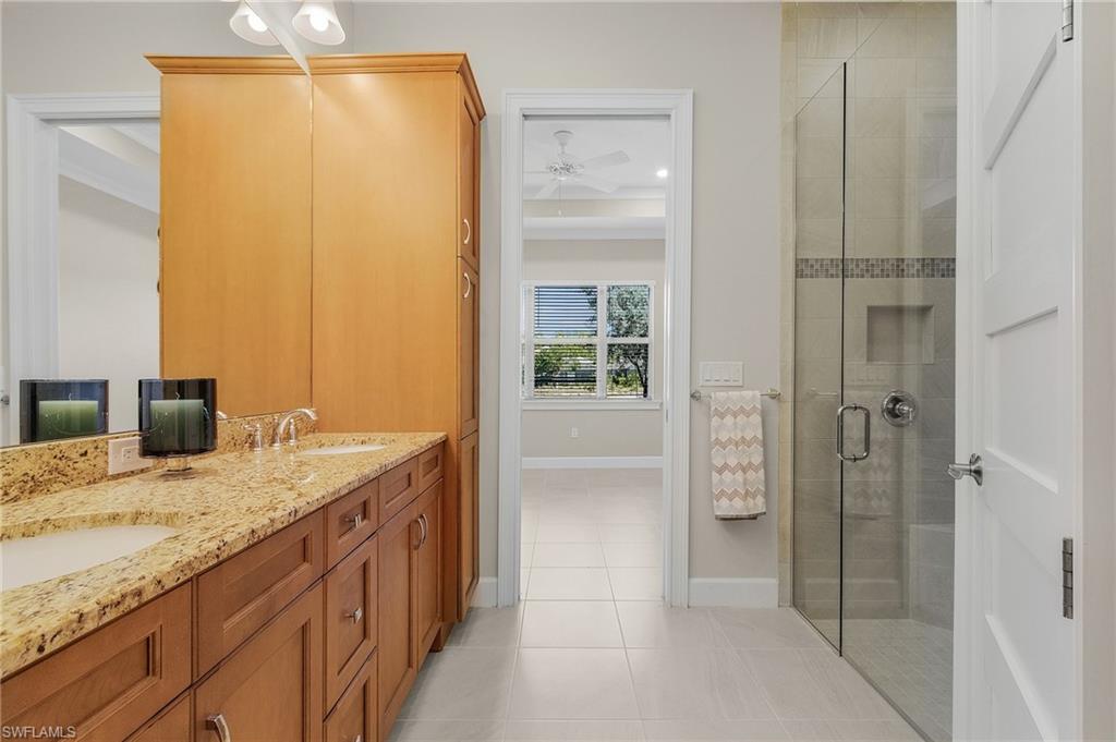 5731 Highbourne Drive Naples, FL 34113 - Photo 10 of 20 Master Bathroom with vanity, walk-in shower