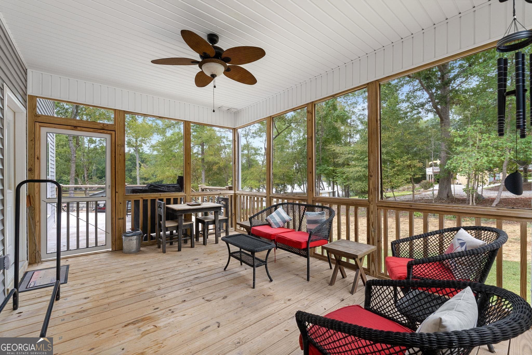 660 Doe Lane Mansfield, GA 30055 - Photo 17 of 45 a living room with furniture floor to ceiling windows and a table