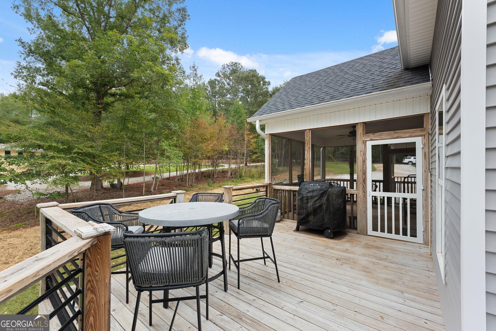660 Doe Lane Mansfield, GA 30055 - Photo 18 of 45 a view of a patio with table and chairs with wooden floor and fence
