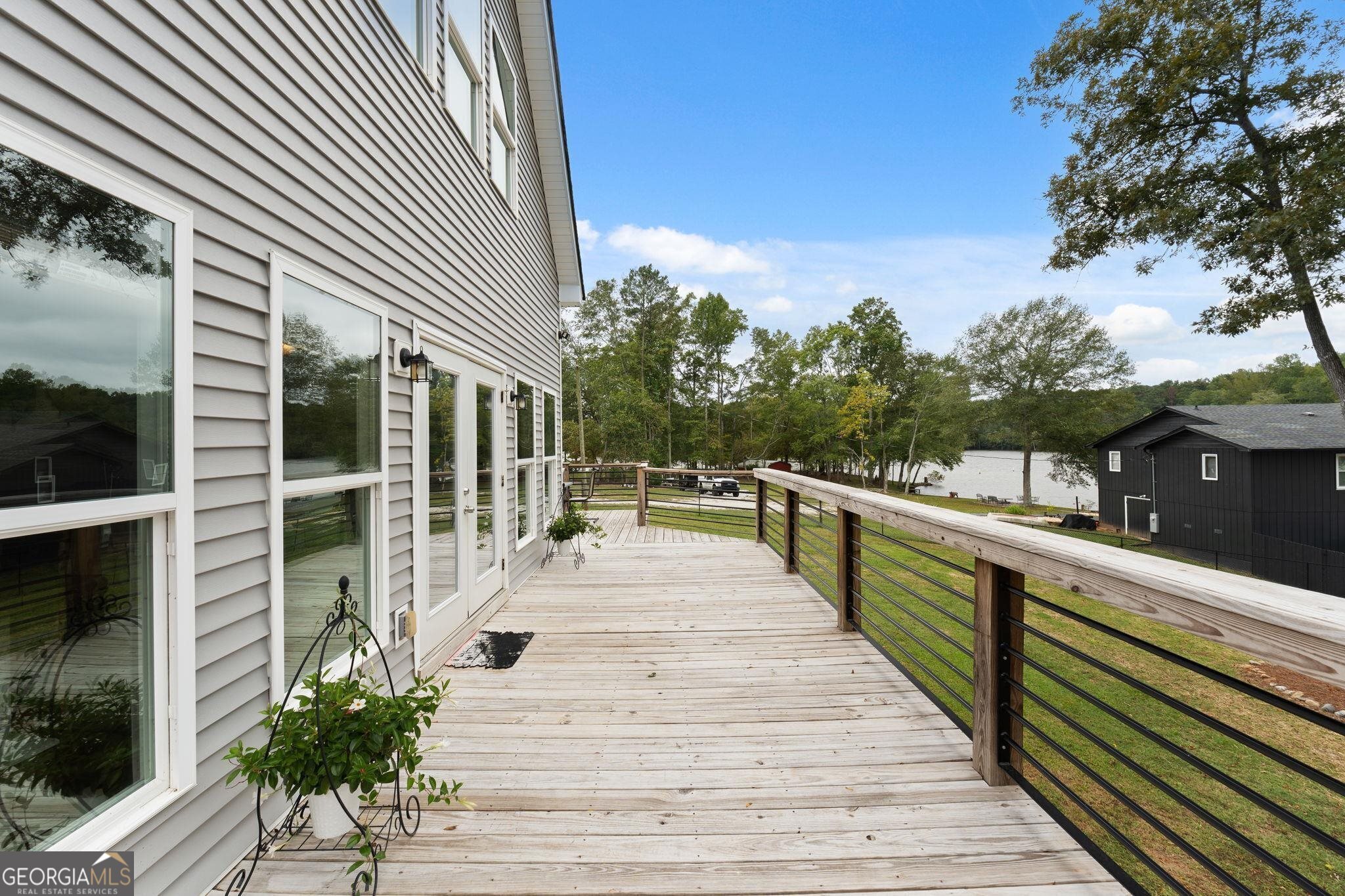 660 Doe Lane Mansfield, GA 30055 - Photo 19 of 45 a view of balcony and deck with wooden floor and fence