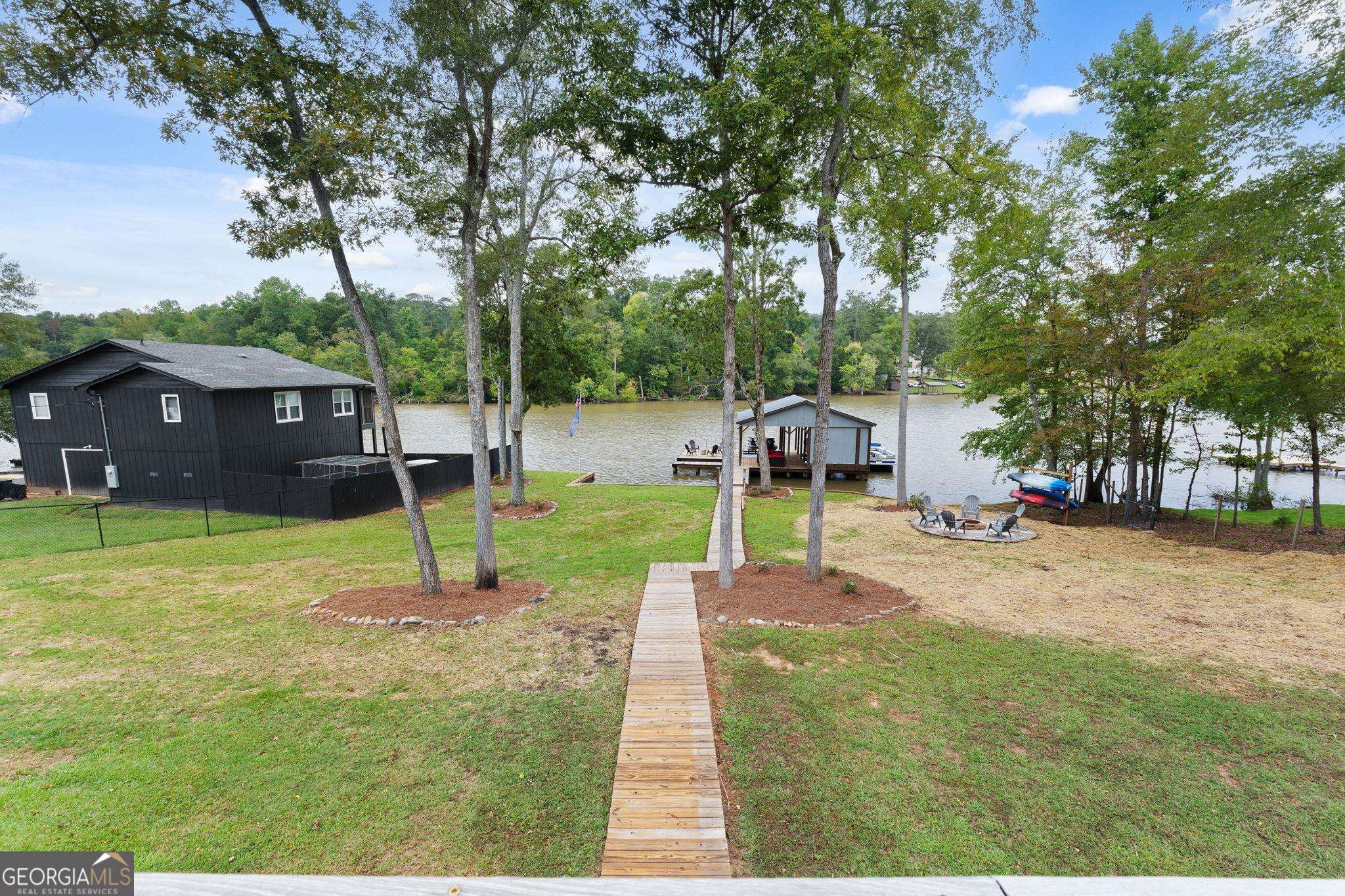 660 Doe Lane Mansfield, GA 30055 - Photo 21 of 45 a swimming pool with lots of tress in front of it