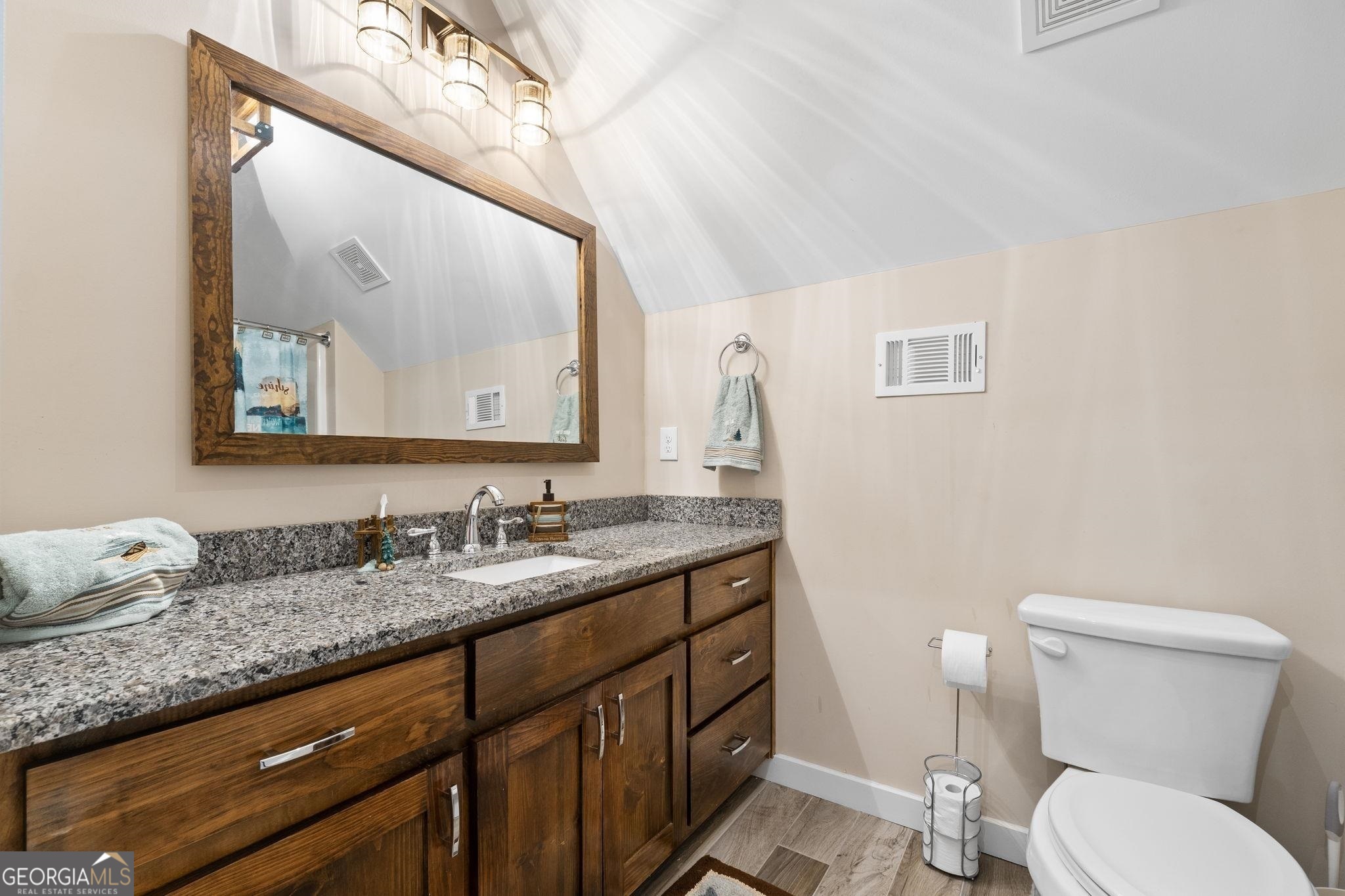 660 Doe Lane Mansfield, GA 30055 - Photo 29 of 45 a bathroom with a granite countertop toilet sink and mirror