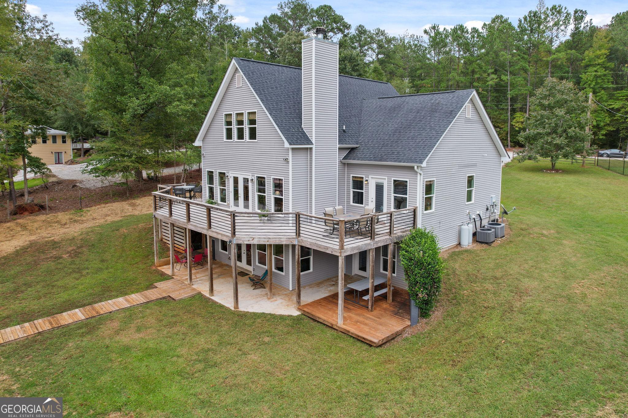 660 Doe Lane Mansfield, GA 30055 - Photo 3 of 45 an aerial view of a house having patio with a garden