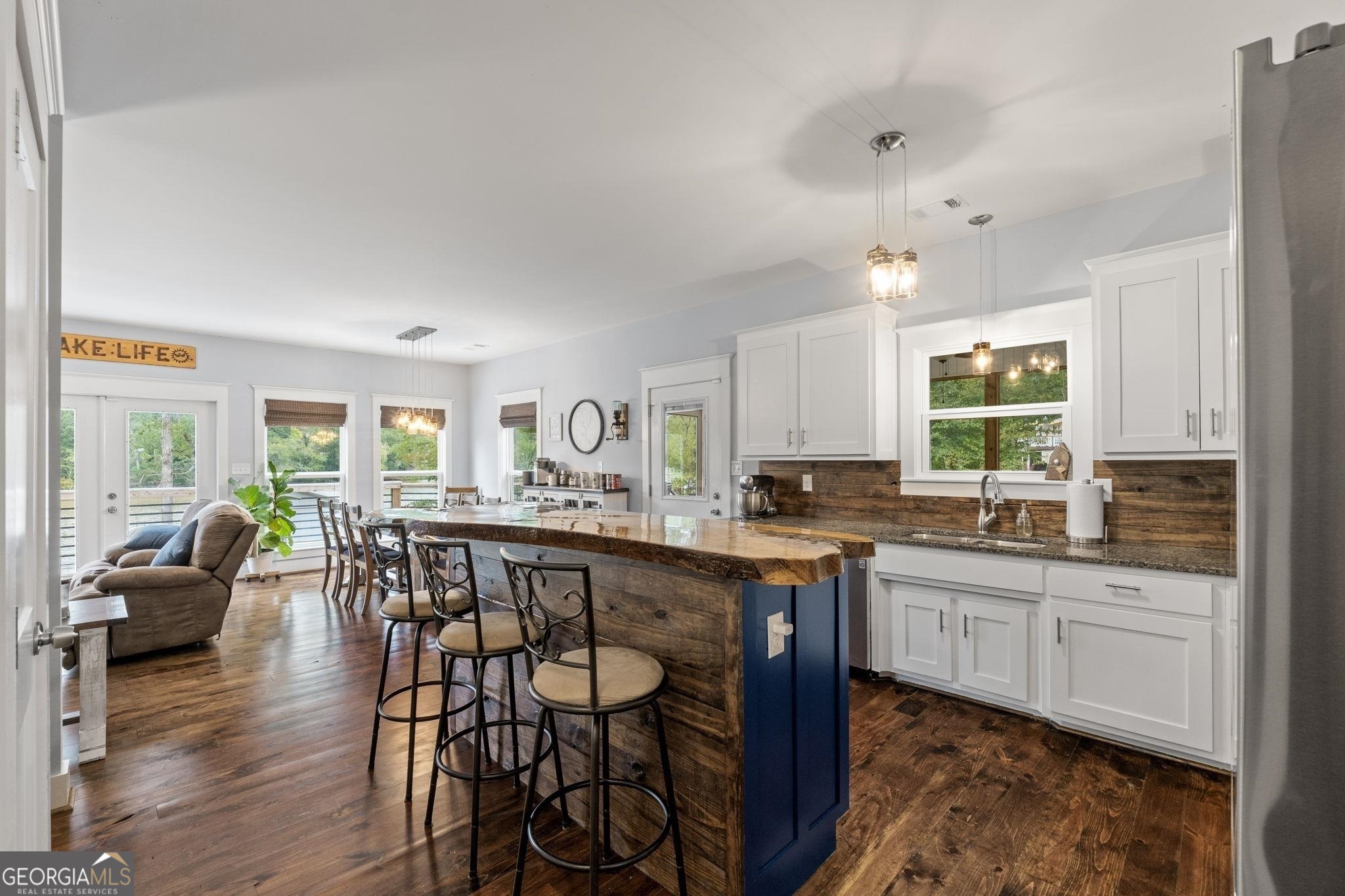 660 Doe Lane Mansfield, GA 30055 - Photo 5 of 45 a large kitchen with cabinets a sink a dining table and chairs