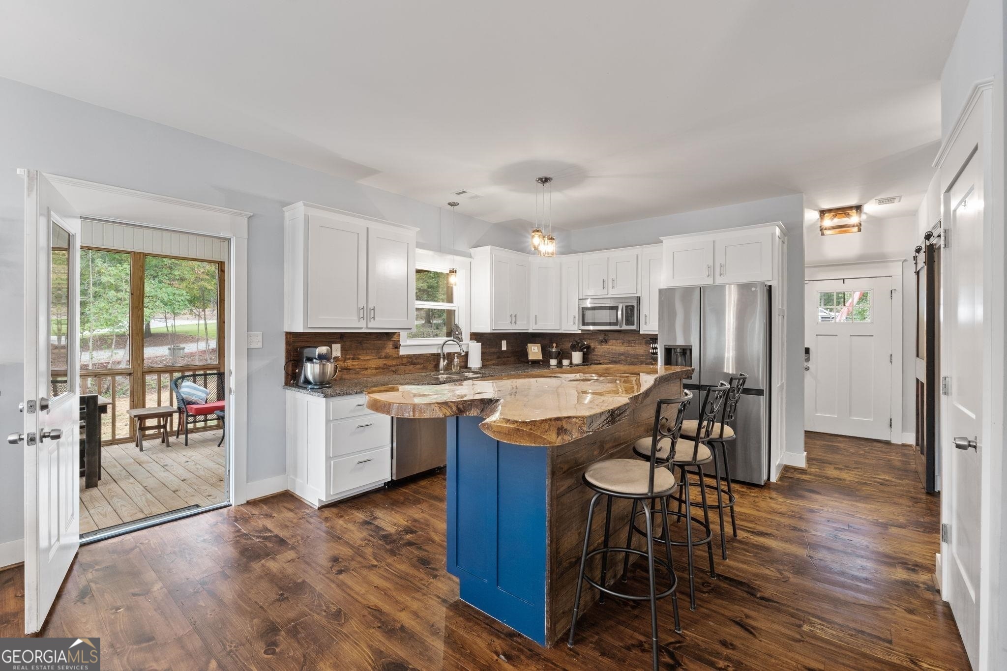 660 Doe Lane Mansfield, GA 30055 - Photo 6 of 45 a kitchen with a table chairs refrigerator and cabinets
