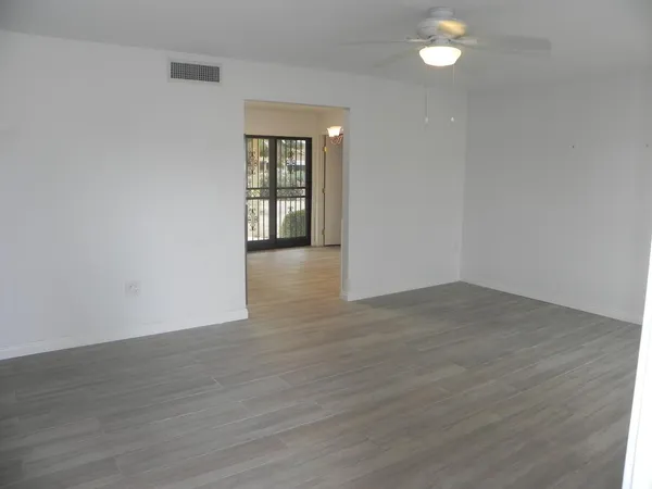 a white toilet sitting next to a shower