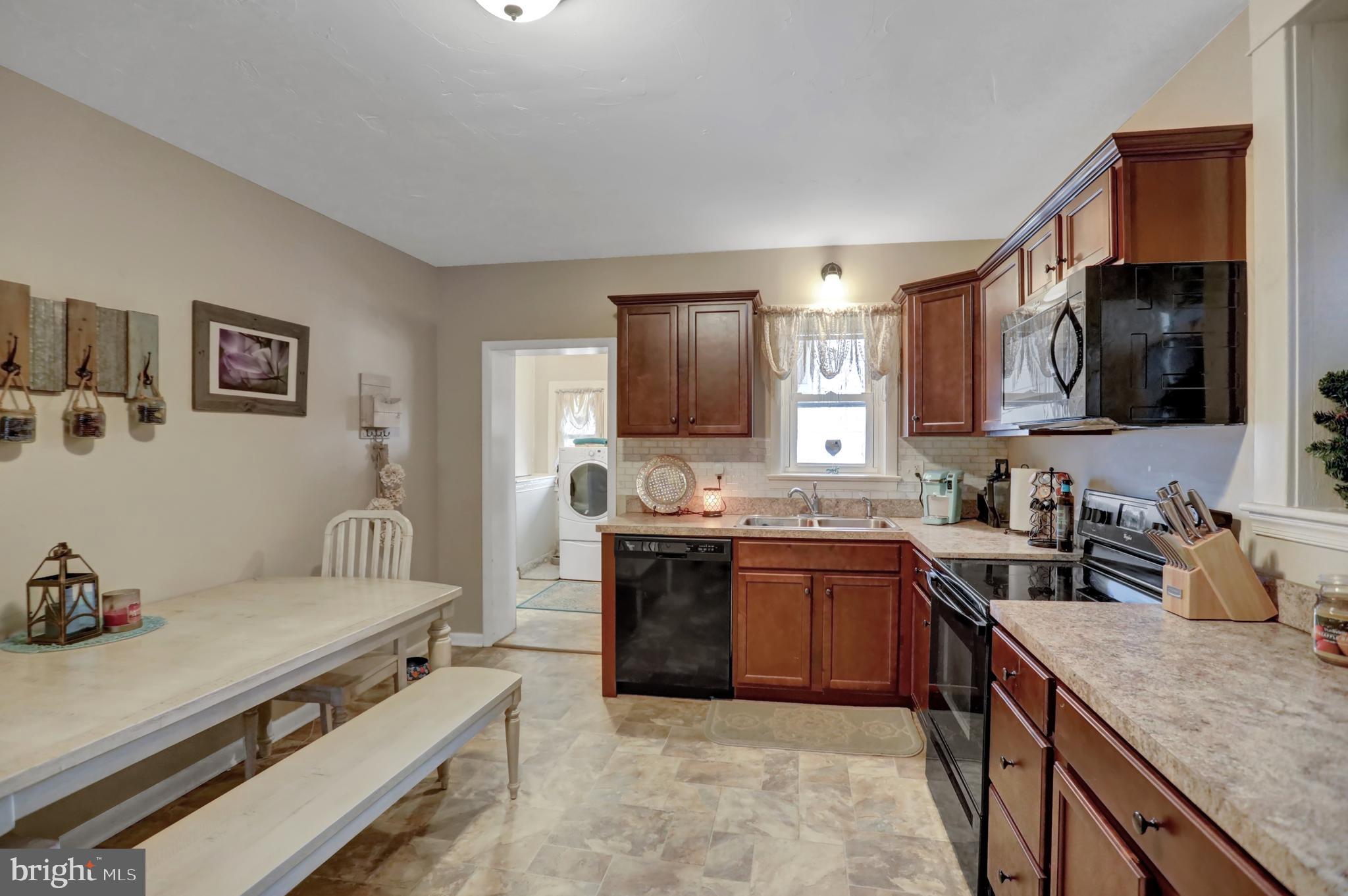 59 South Main Street Spring Grove, PA 17362 - Photo 12 of 50 a kitchen with stainless steel appliances granite countertop a sink stove and refrigerator
