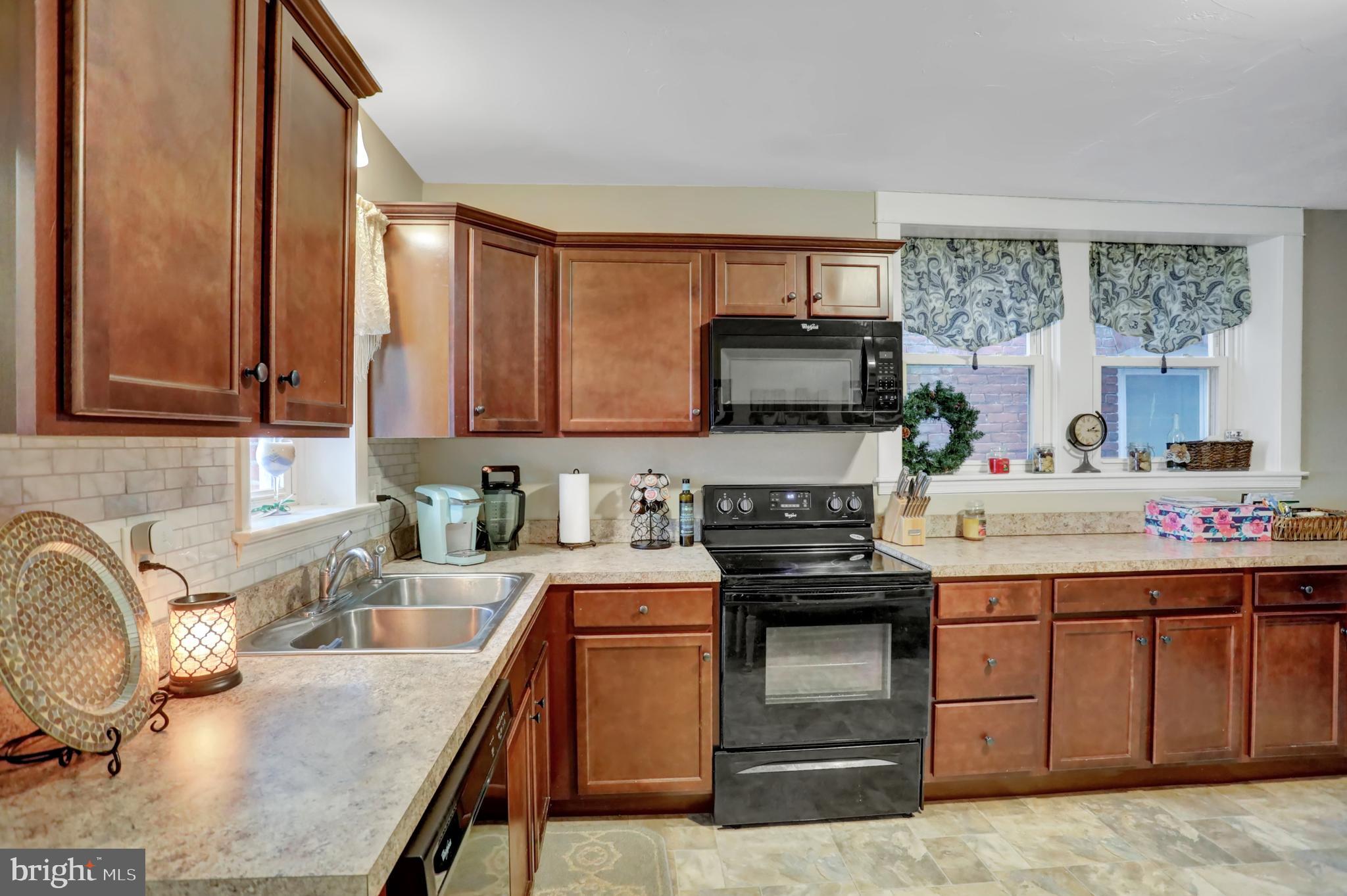59 South Main Street Spring Grove, PA 17362 - Photo 13 of 50 a kitchen with a sink stove and microwave