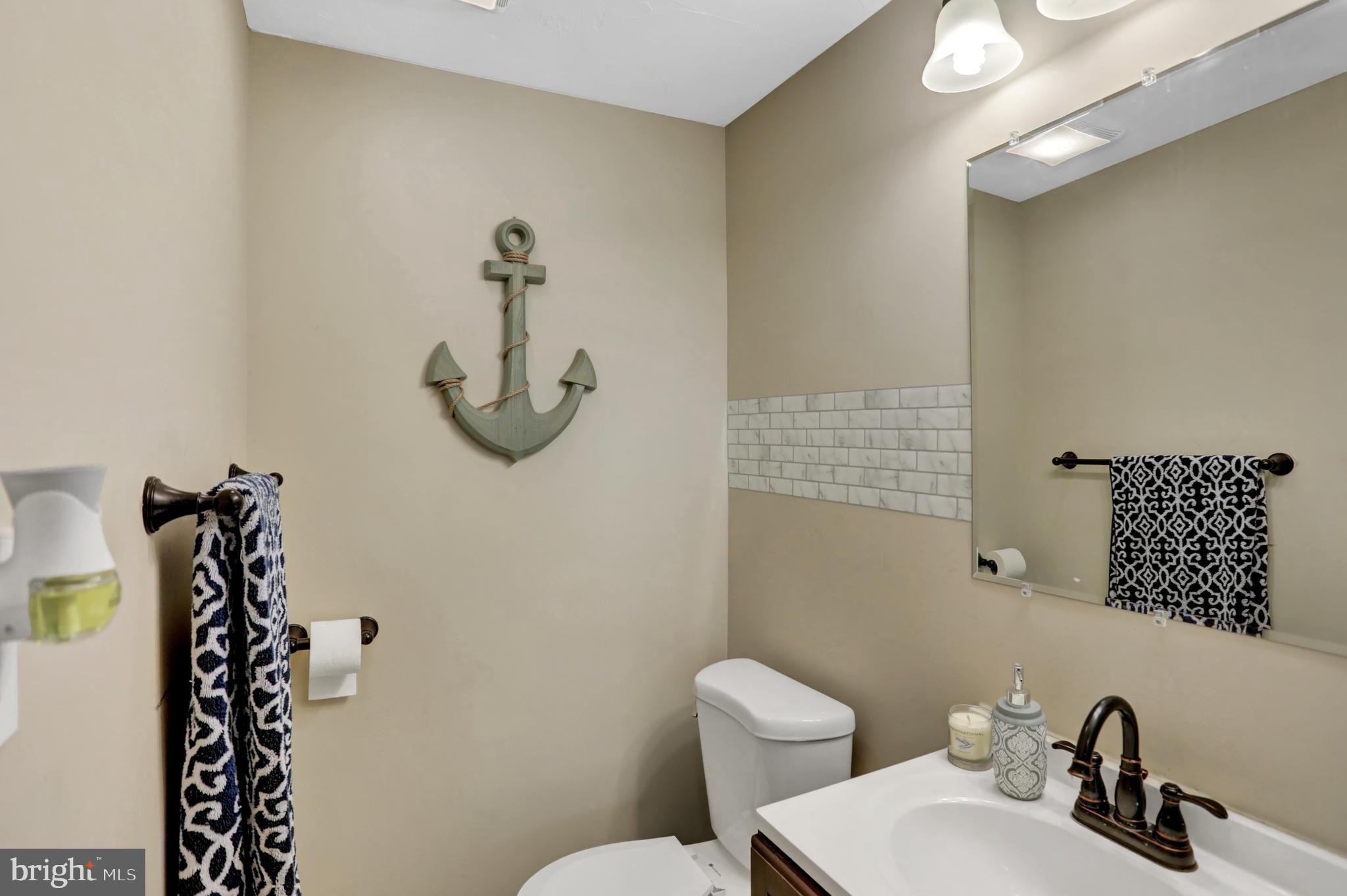 59 South Main Street Spring Grove, PA 17362 - Photo 19 of 50 a bathroom with a toilet a sink and mirror