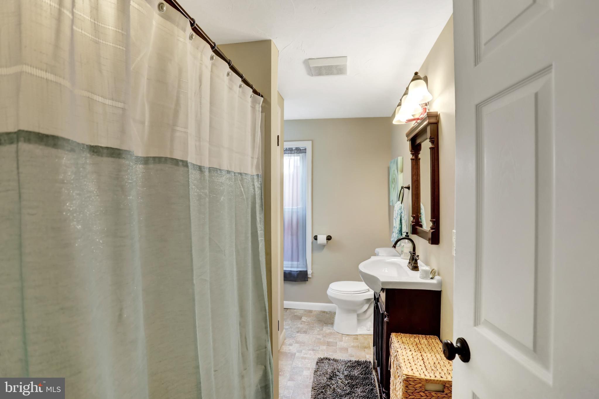 59 South Main Street Spring Grove, PA 17362 - Photo 23 of 50 a bathroom with a sink a mirror and a shower curtain