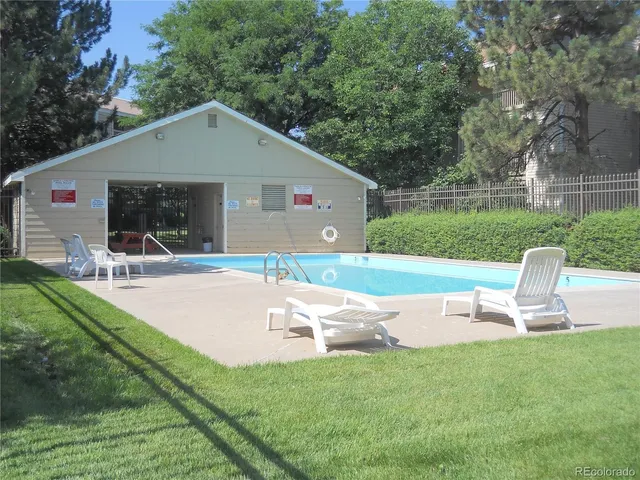 a view of a backyard with table and chairs with a yard and plants