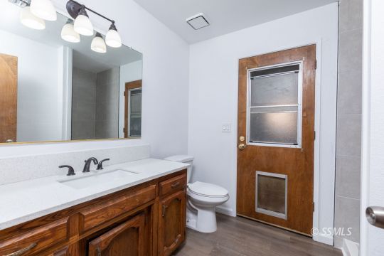 718 Sonja Avenue Ridgecrest, CA 93555 - Photo 14 of 33 a bathroom with a sink vanity and toilet