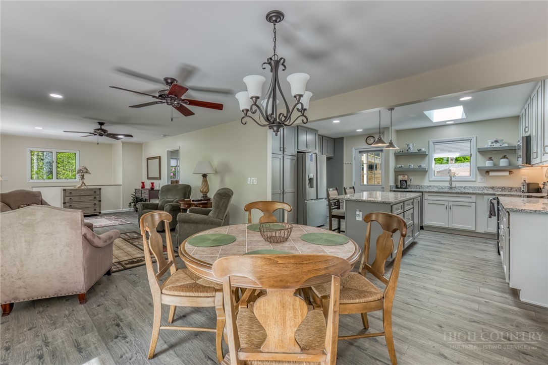 174 Spruce Pine Road Newland, NC 28657 - Photo 14 of 50 a view of a dining room with furniture and a chandelier