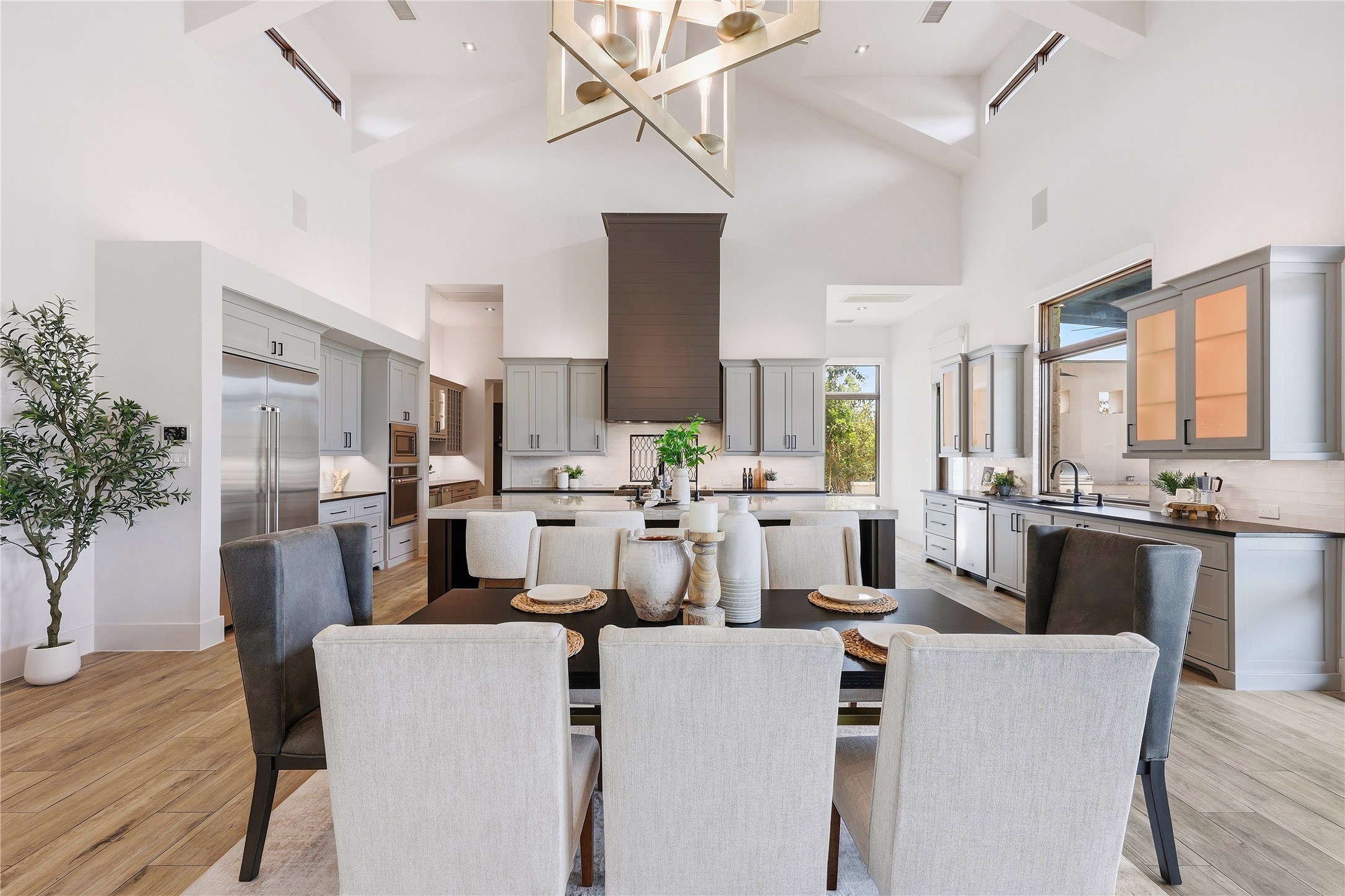 449 Ranch Falls Fair Oaks Ranch, TX 78015 - Photo 12 of 39 High vaulted ceilings and rich wood-look flooring elevate this open-concept culinary space.