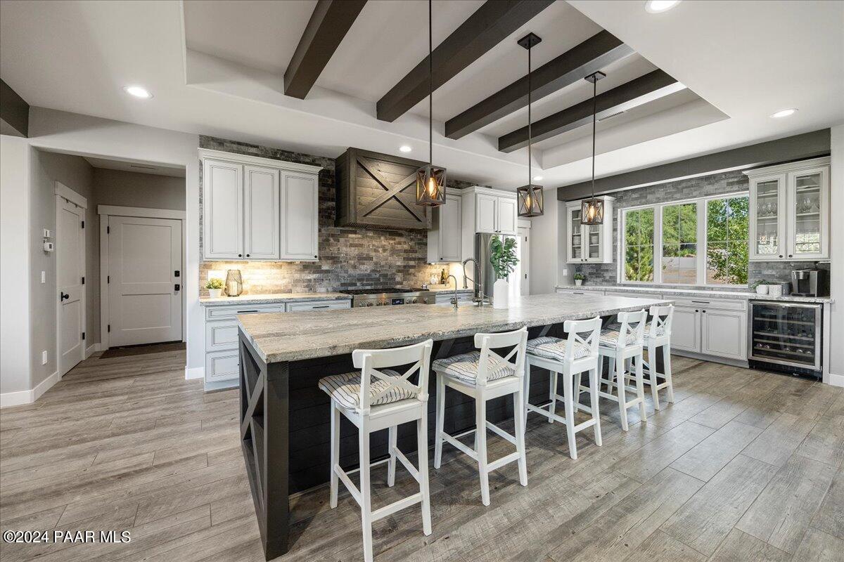 1947 Shadow Valley Drive Prescott, AZ 86305 - Photo 13 of 54 a kitchen with stainless steel appliances granite countertop a table chairs and a wooden floor