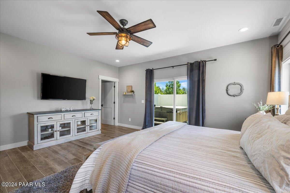 1947 Shadow Valley Drive Prescott, AZ 86305 - Photo 21 of 54 a bedroom with a large bed and a flat screen tv