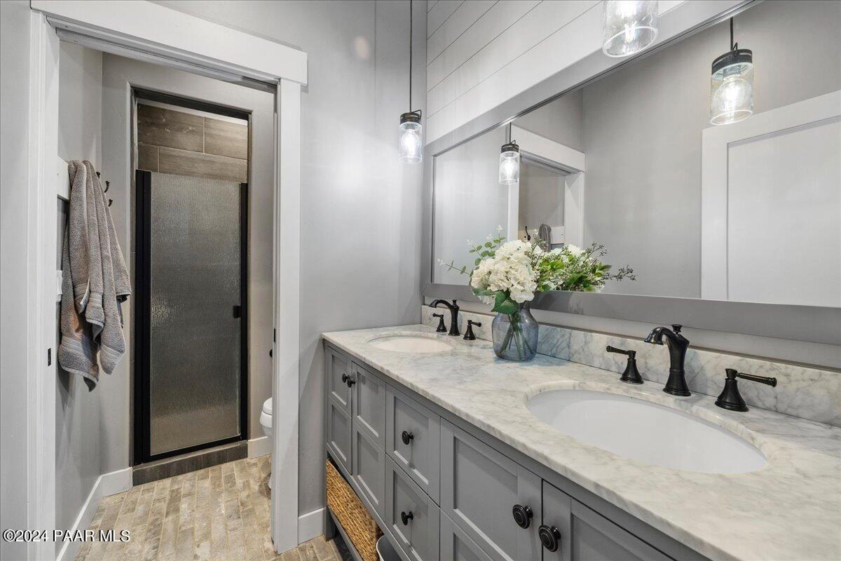 1947 Shadow Valley Drive Prescott, AZ 86305 - Photo 33 of 54 a bathroom with a granite countertop sink and a mirror