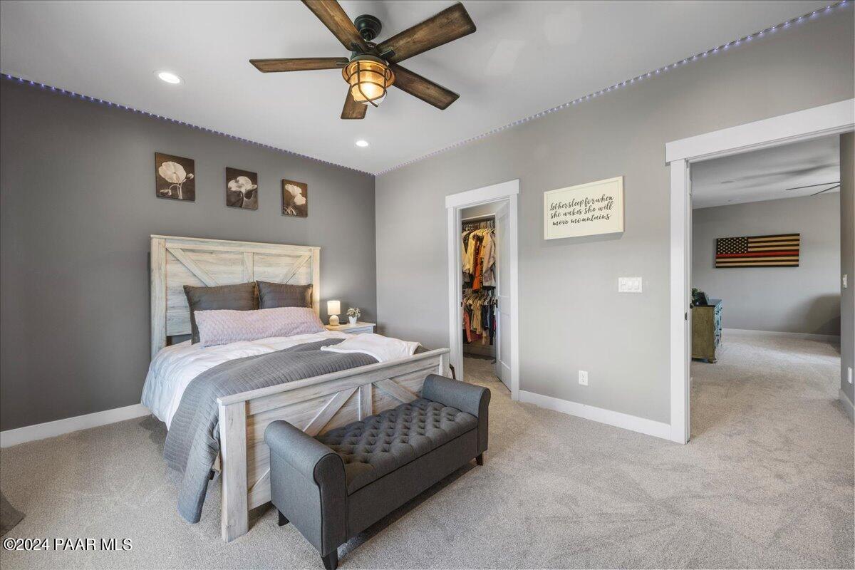 1947 Shadow Valley Drive Prescott, AZ 86305 - Photo 35 of 54 a bedroom with a bed and a chandelier