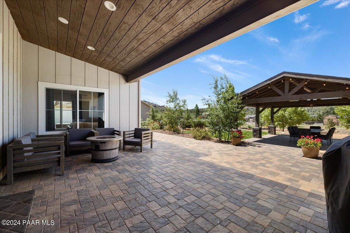 1947 Shadow Valley Drive Prescott, AZ 86305 - Photo 38 of 54 a view of a patio with furniture and a lawn chairs under an umbrella
