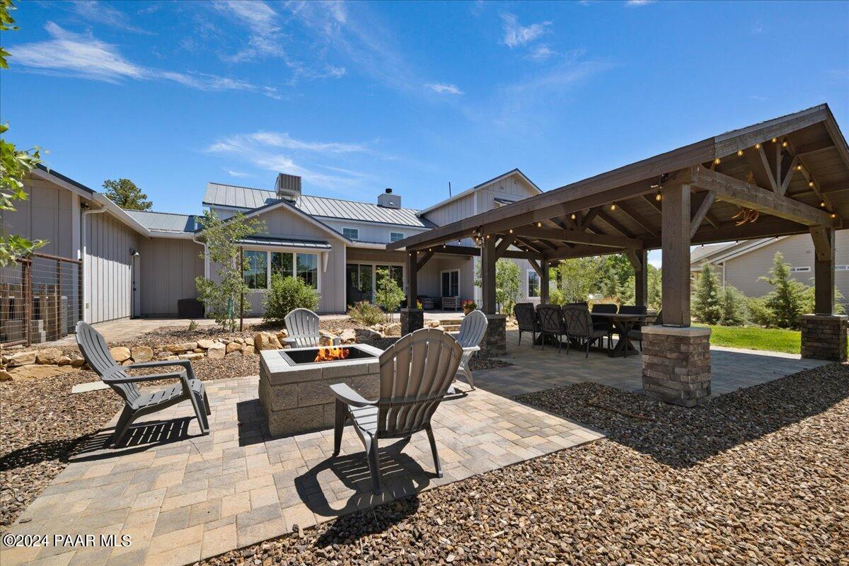 1947 Shadow Valley Drive Prescott, AZ 86305 - Photo 43 of 54 a view of a patio with a table and chairs under an umbrella