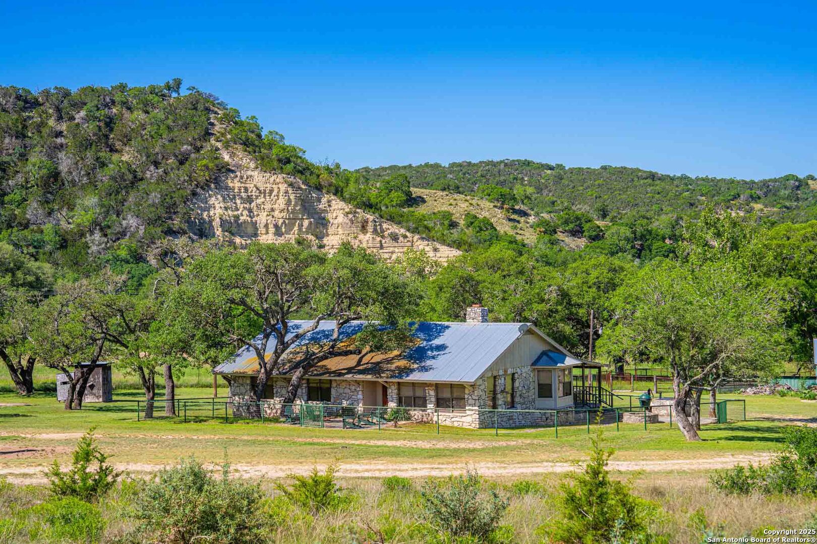 165 Flach Road Comfort, TX 78013 - Photo 26 of 69 a view of a big house with a big yard and large trees