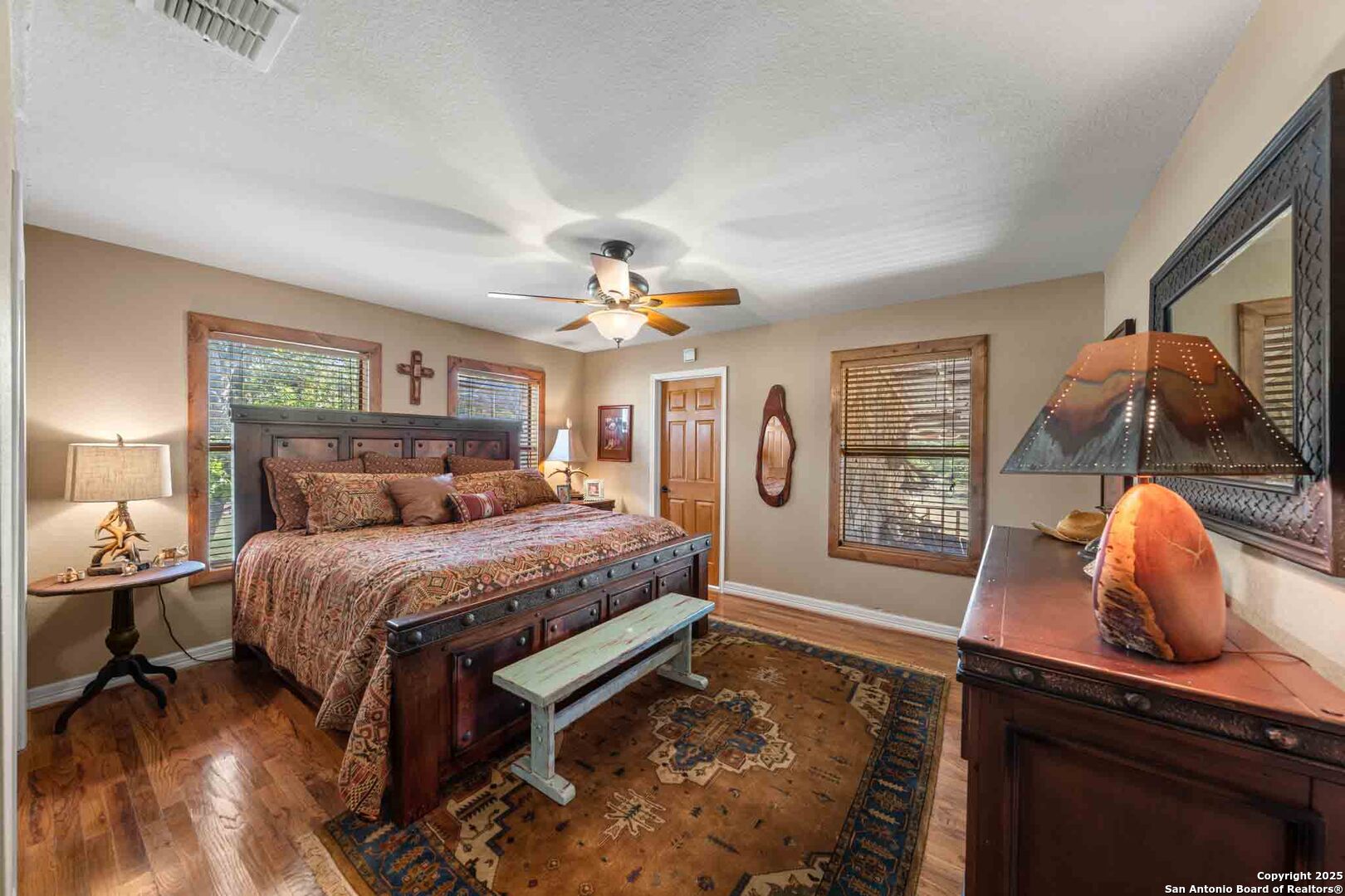 165 Flach Road Comfort, TX 78013 - Photo 37 of 69 a spacious bedroom with a bed and dresser with mirror