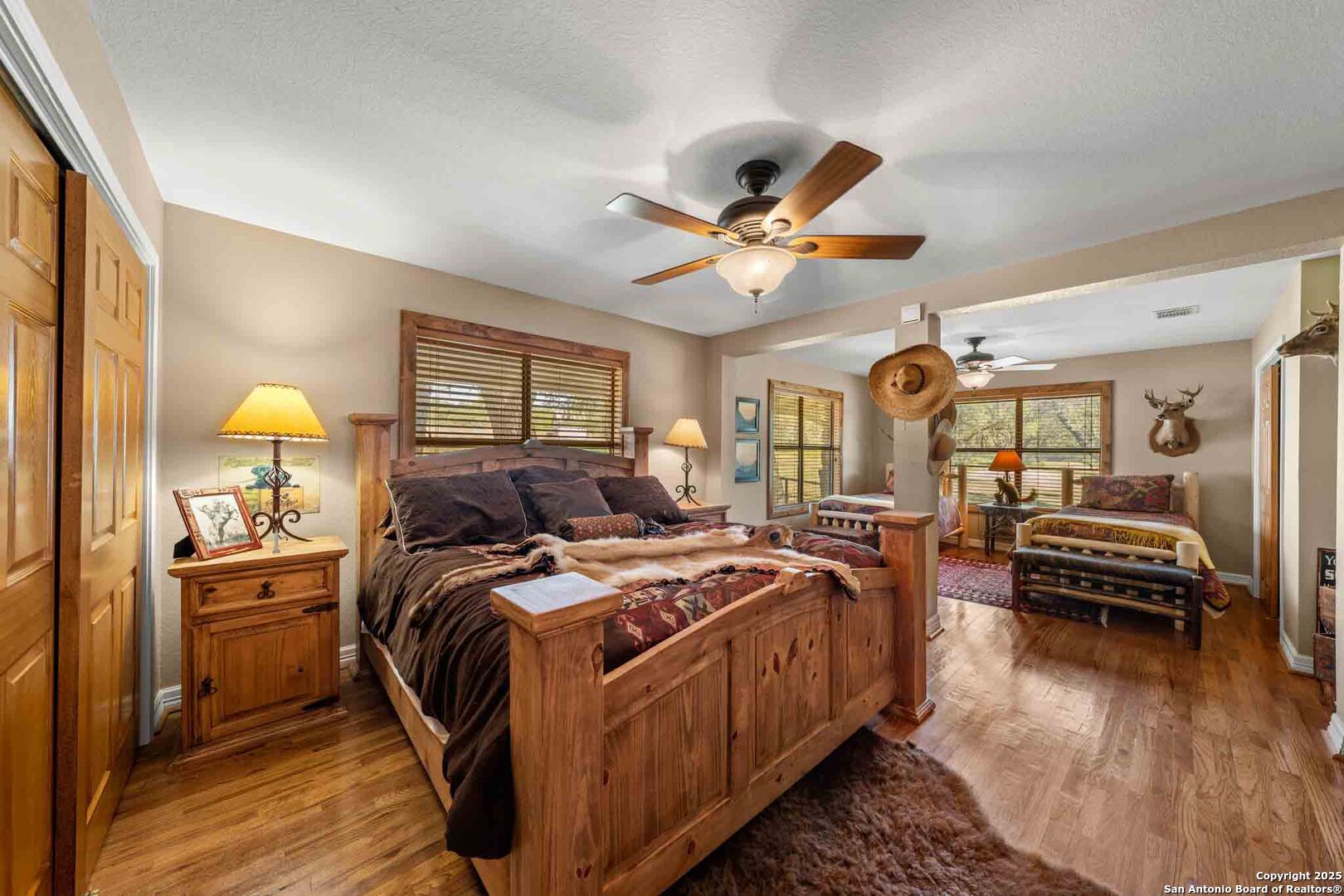 165 Flach Road Comfort, TX 78013 - Photo 40 of 69 a bedroom with a bed and a chandelier