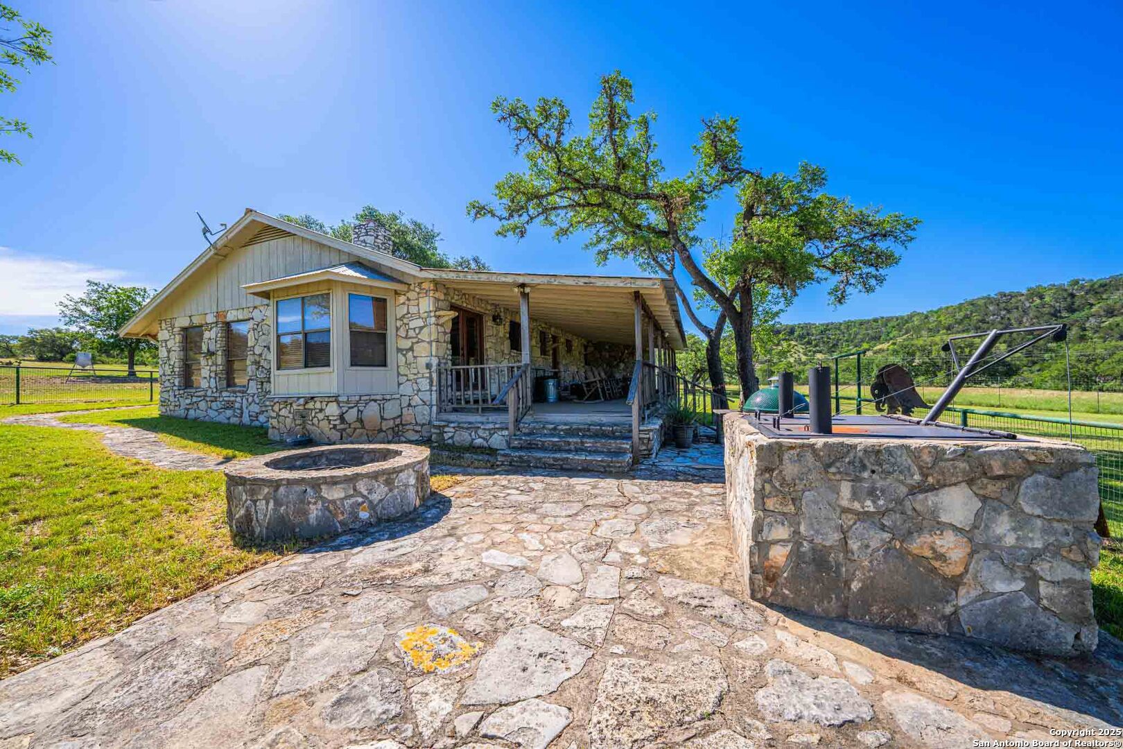 165 Flach Road Comfort, TX 78013 - Photo 44 of 69 a front view of a house with swimming pool fire pit and outdoor seating