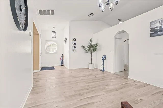 a view of empty room with a mirror