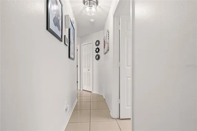 a view of a hallway with wooden floor and entryway