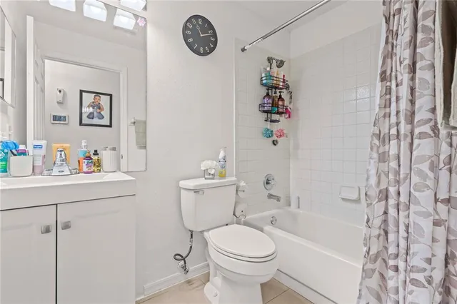 a bathroom with a toilet sink vanity tub and mirror