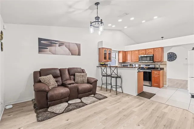 a living room with furniture and kitchen view