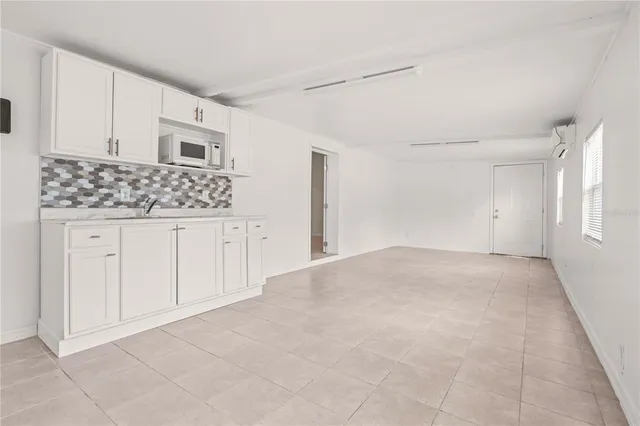 a view of a kitchen with white cabinets